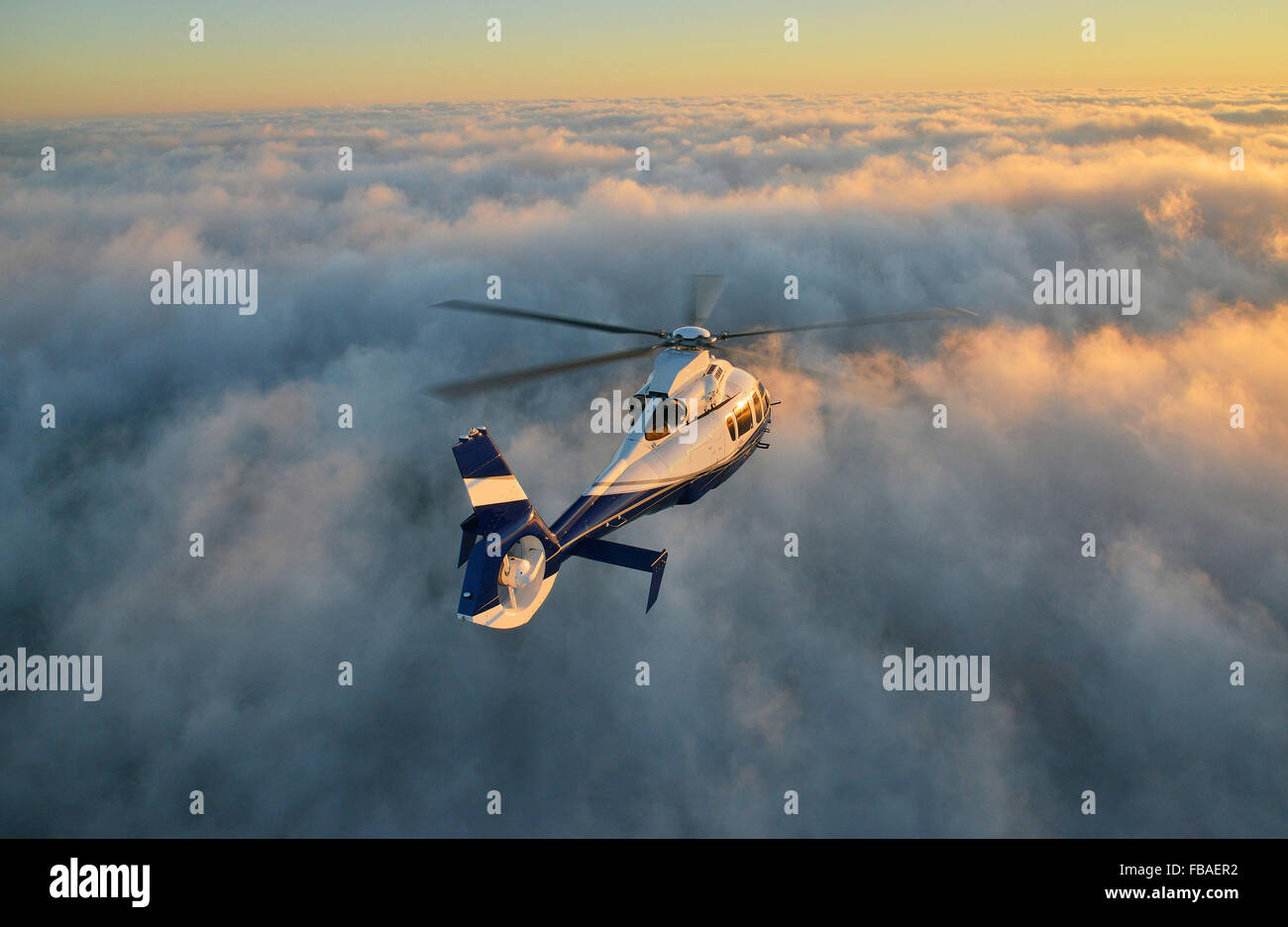 Corporate Helicopter above clouds Stock Photo