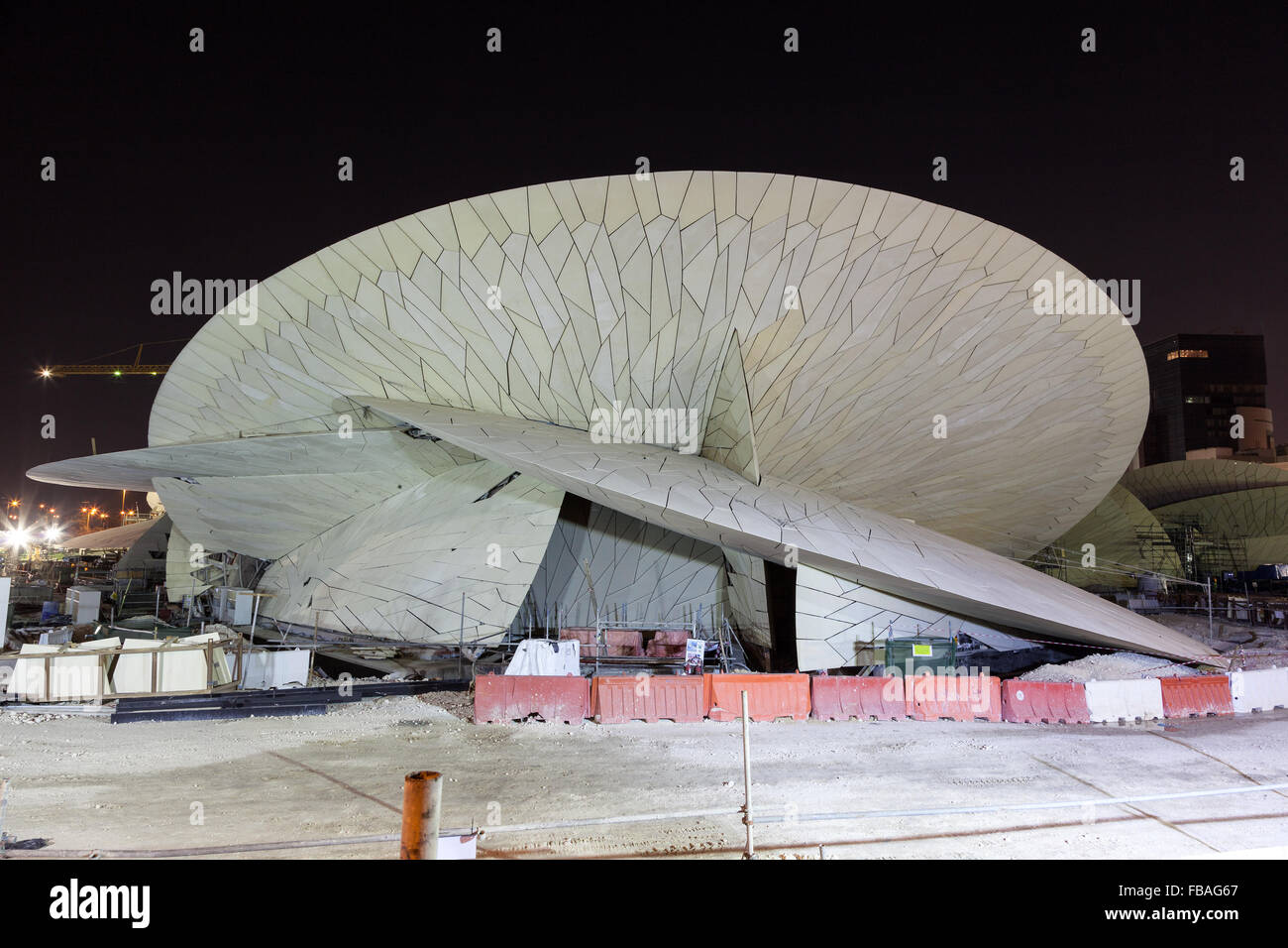 Construction site of the Qatar National Museum at night Stock Photo