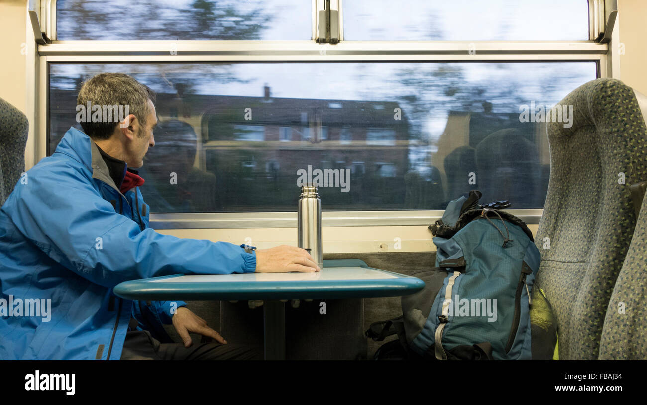 Mature male hiker on 7.am early morning train from Middlesbrough to Whitby on the picturesque Esk Valley Railway. Stock Photo