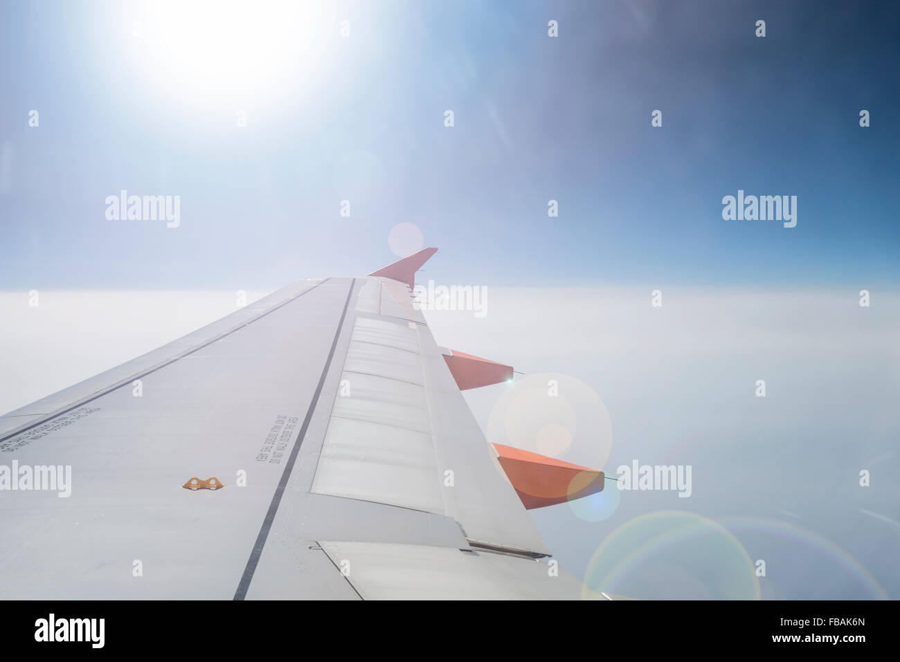 View from plane window looking into the sun Stock Photo