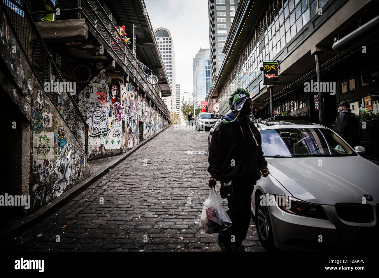 Man walking to the Post Alley under Pike Place Market, Seattle ...