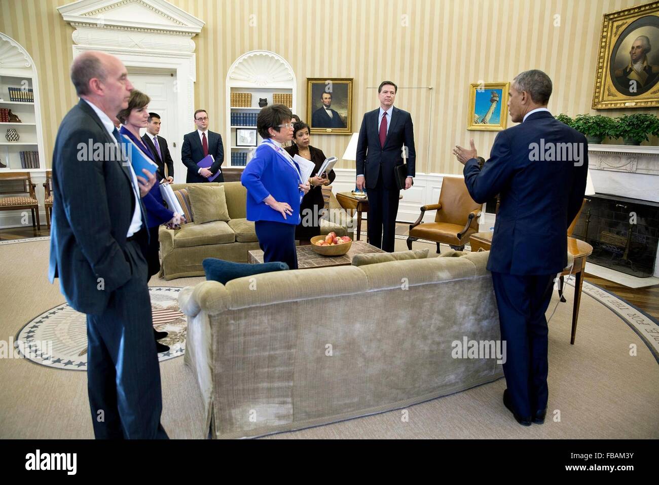 U.S President Barack Obama speaks with the attendees following a meeting on the executive actions he can take to curb gun violence in the Oval Office of the White House January 4, 2016 in Washington, DC. Listening to the President, from left: Neil Eggleston, Counsel to the President; Deputy Attorney General Sally Yates; Eric Nguyen, Associate Counsel to the President; Michael Bosworth, Deputy Counsel to the President; Senior Advisor Valerie Jarrett; Attorney General Loretta Lynch; Natalie Quillian, Deputy Assistant to the President and FBI Director James Comey. Stock Photo