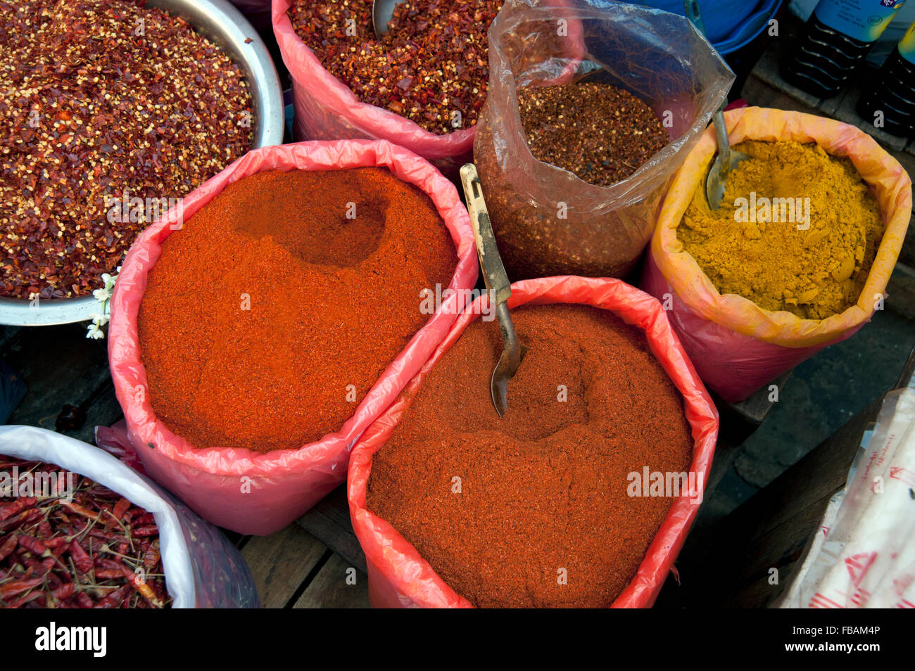 Detail of dried chillies flakes curry powders and spices at a street market Rangoon Myanmar Stock Photo
