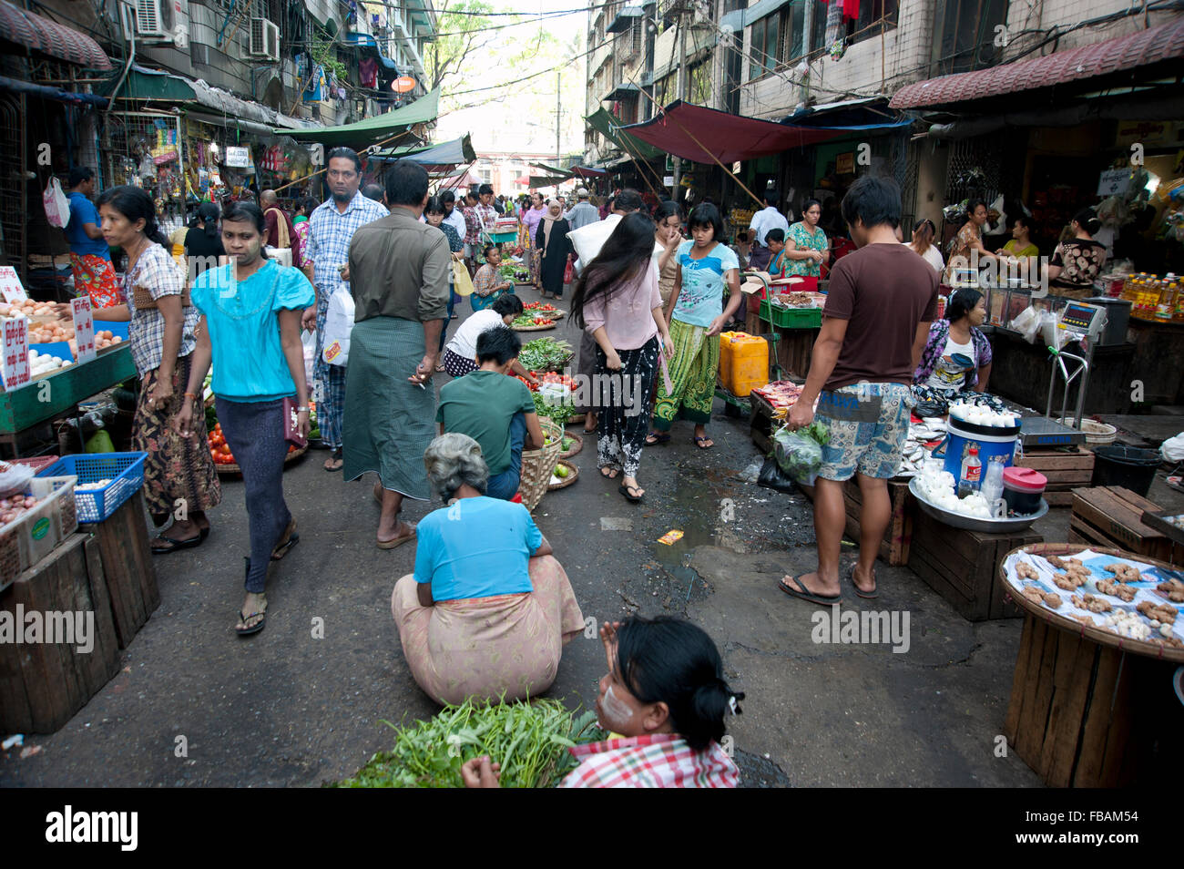 Hindu, Muslim and Buddhist shop side by side on one of Yangon's many fresh food street markets Myanmar Stock Photo