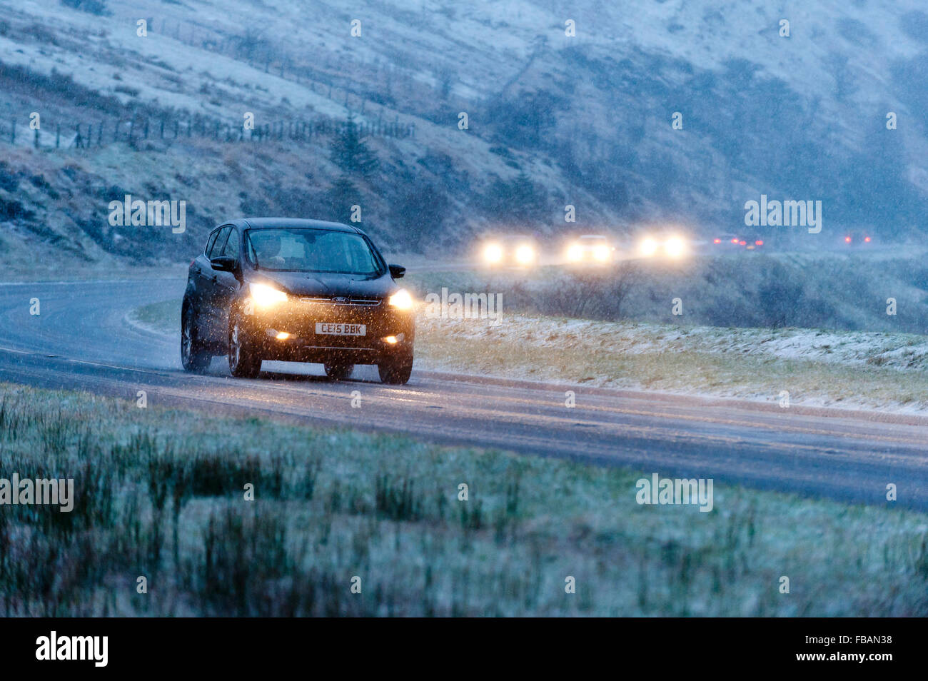 Brecon, Powys, Wales, UK. 13th January, 2016. Traffic negotiates the A470 road over the Brecon Beacons near the Storey Arms during a blizzard of sleet and snow. Credit:  Graham M. Lawrence/Alamy Live News. Stock Photo