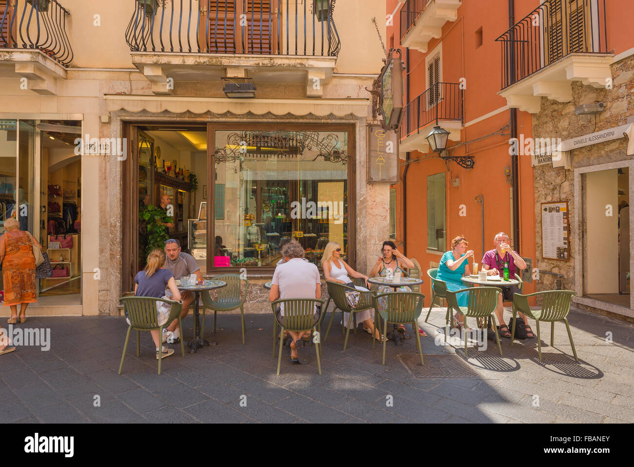 Taormina cafe bar, view in summer of tourists relaxing at tables outside a cafe on the Corso Umberto I in Taormina, Sicily. Stock Photo