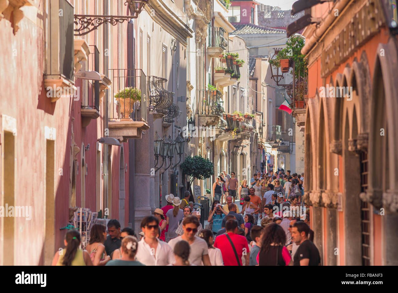 Taormina sicily people, view of tourists in summer walking in the Corso Umberto I - the main street in the old town area of Taormina, Sicily. Stock Photo