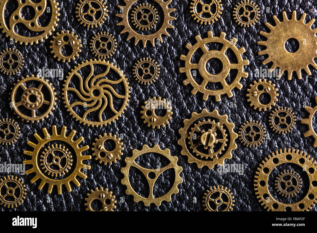 steampunk mechanical cogs gears wheels on wooden background Stock Photo