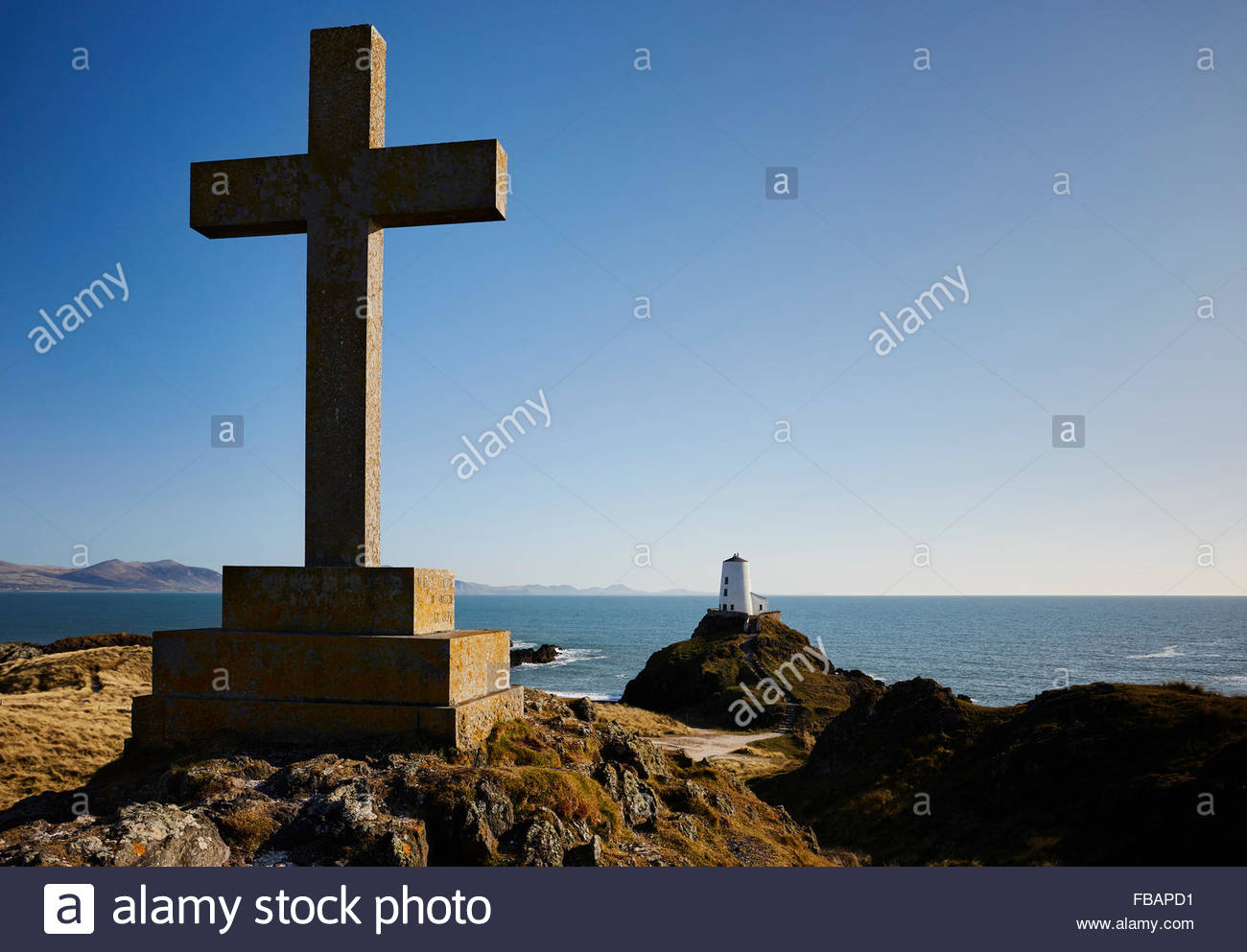 stone cross and tower on Llanddwyn Island Anglesey north Wales UK Stock Photo