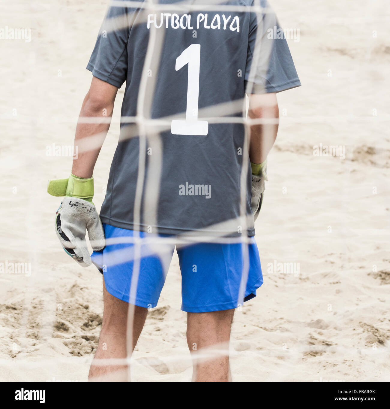 Rear view of goalkeeper at beach football tournament in Spain. Futbol Playa is Spanish for beach football Stock Photo