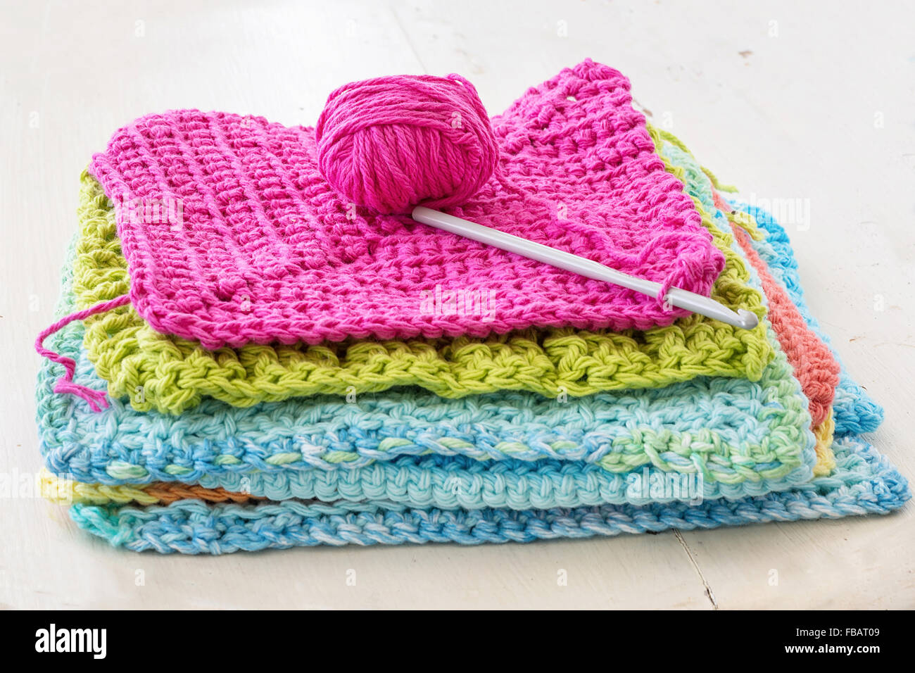 Crocheted dishcloths, with a hook and a ball of yarn Stock Photo Alamy