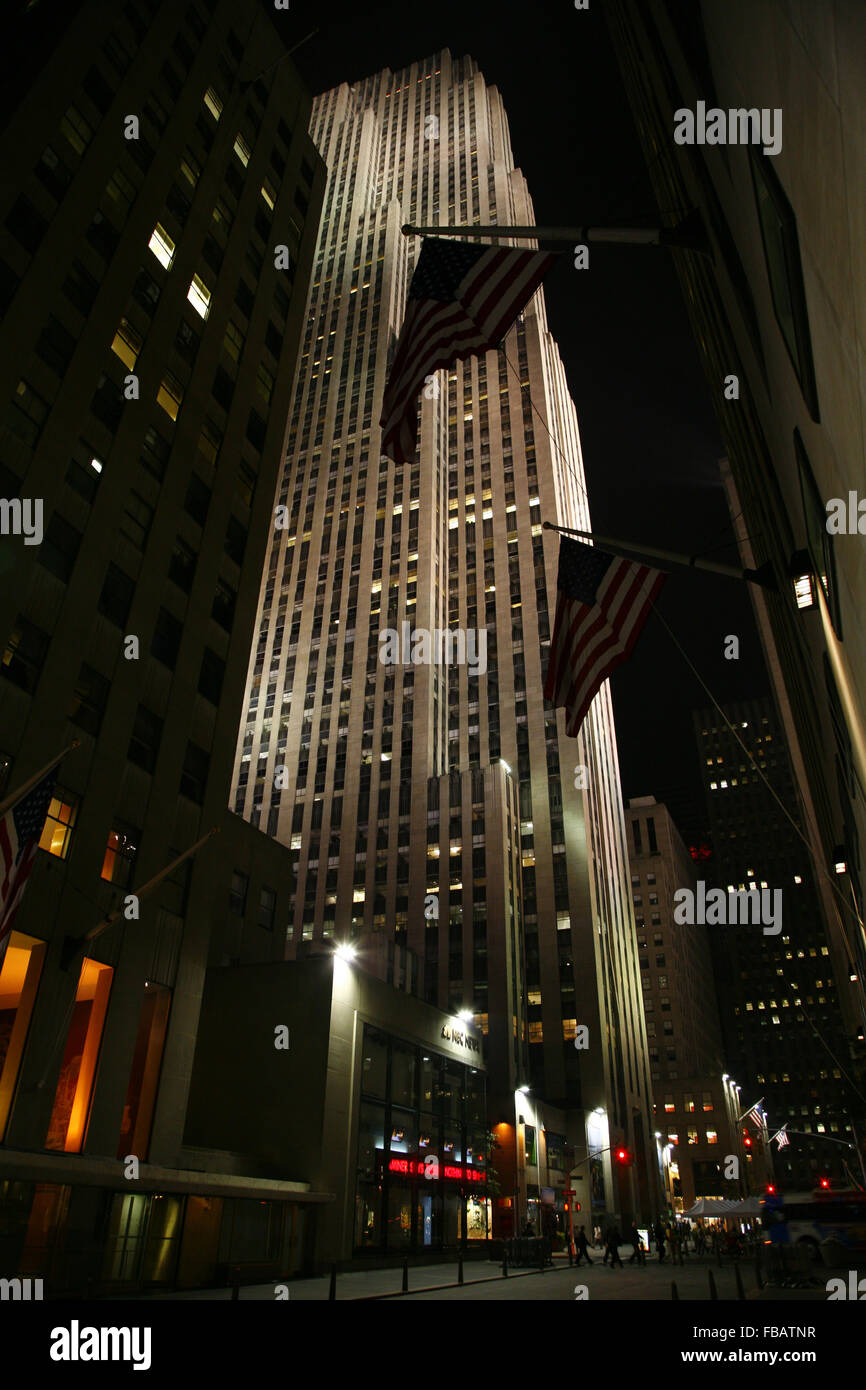 30 Rock, GE Building on Manhattan by night, flooden skyscraper and US flags, New York USA Stock Photo