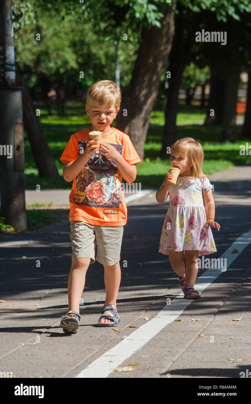 Brother and sister eating ice cream, Vilnius, Lithuania Stock Photo