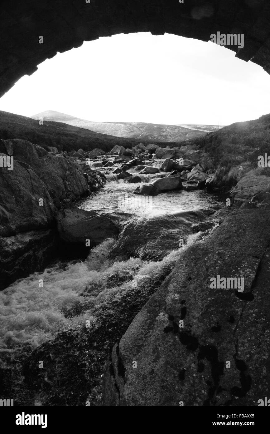 B&W Bridge silhouette and flowing water below Stock Photo - Alamy