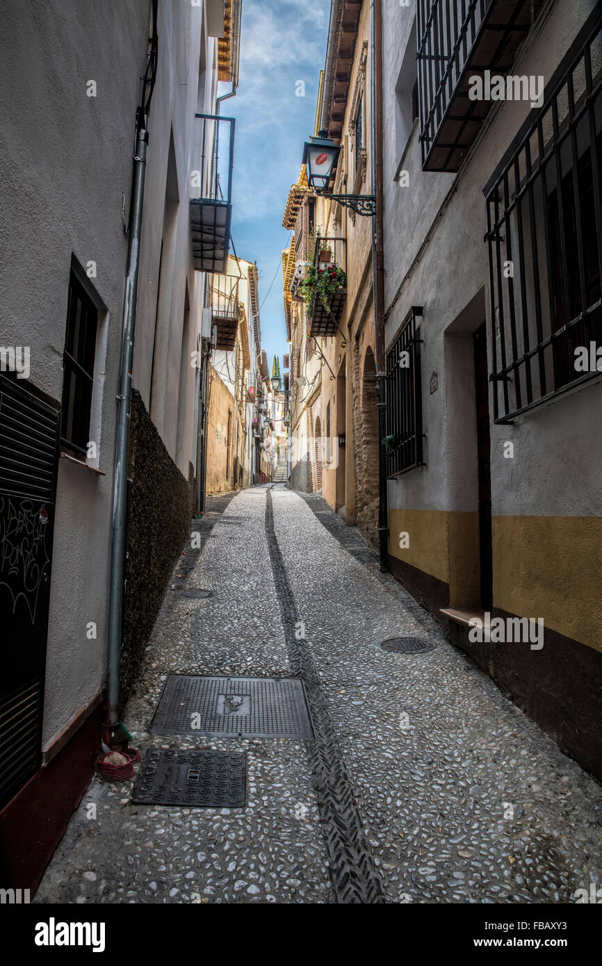 Typical narrow street in Granada in Spain and like many streets in Andalucia Stock Photo