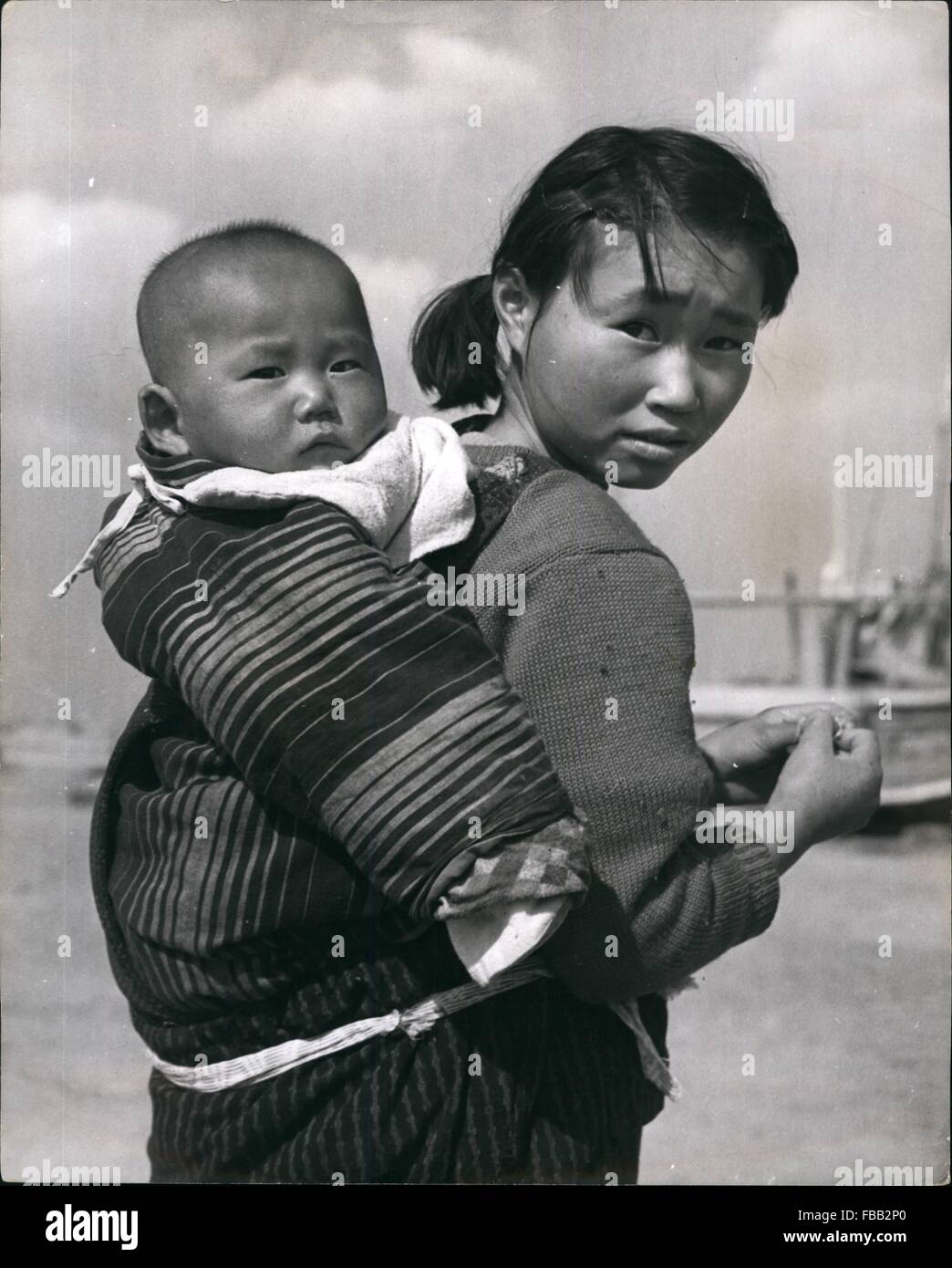 1962 - Cockle Kids: In Katagai They Dig'Em Out with Their Toes: In the Japanese fishing village of Katagi, in Chiab Province not far from Tokyo, the school children spend their holidays and after school hours on the beaches - searching for cockles with their toes! Younger brothers and sisters are carried on their s the young cocklers dig and prie in the soft sand with their almost prehensile toes. The children sell their clothes to anyone wheo will buy them for a fe yen. Further out, their parents wearing waterproof leggings use rakes to drag the and below water, to dislodge the shellfish, w Stock Photo