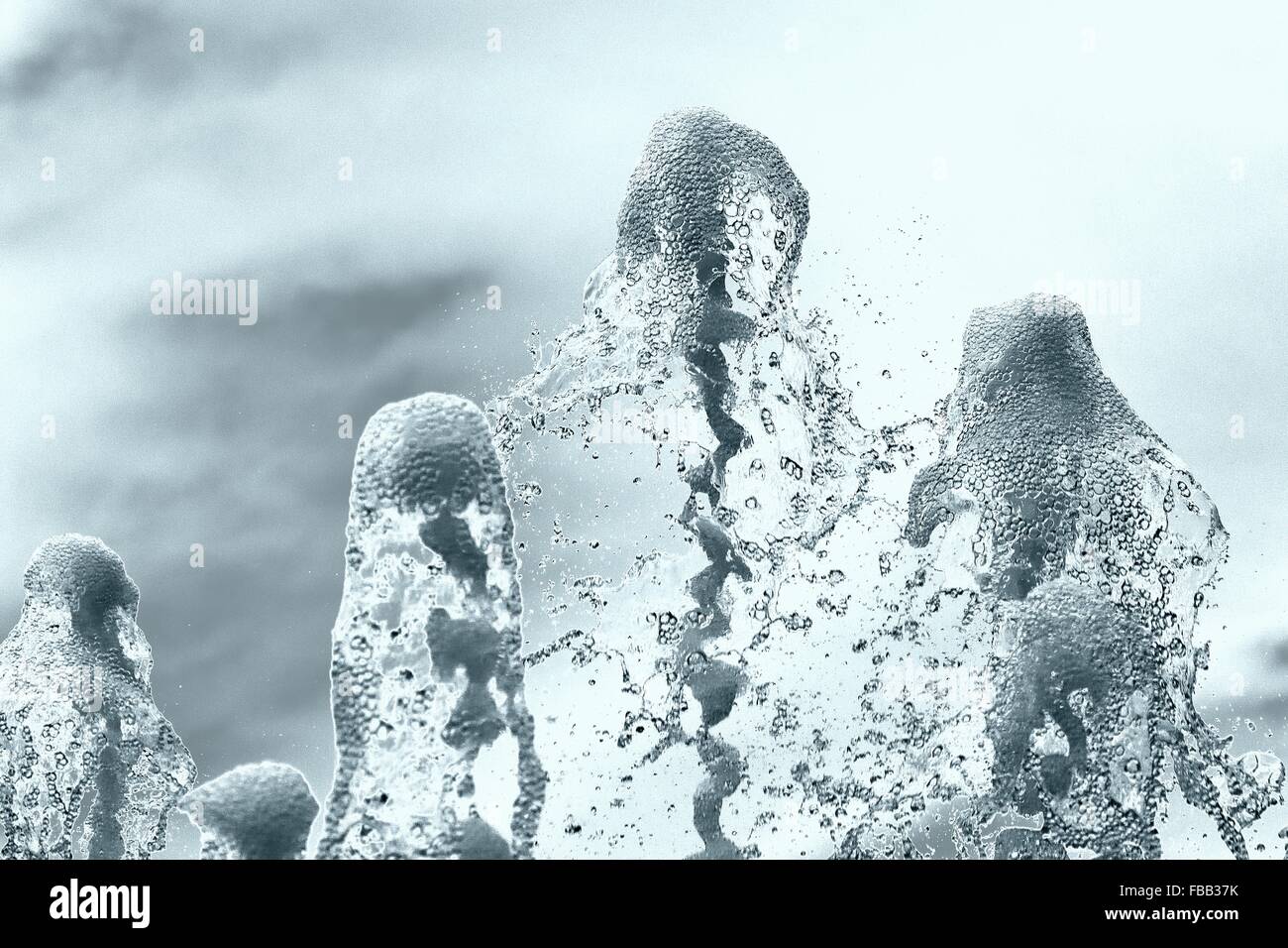 Tops of water jets from fountain. Water columns with bubbles frozen at high speed as it falls back to earth Stock Photo