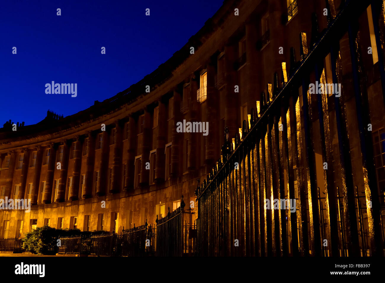 The Royal Crescent in Bath, at night, from a low viewpoint. Section of the historic and beautiful building showing iron railing Stock Photo