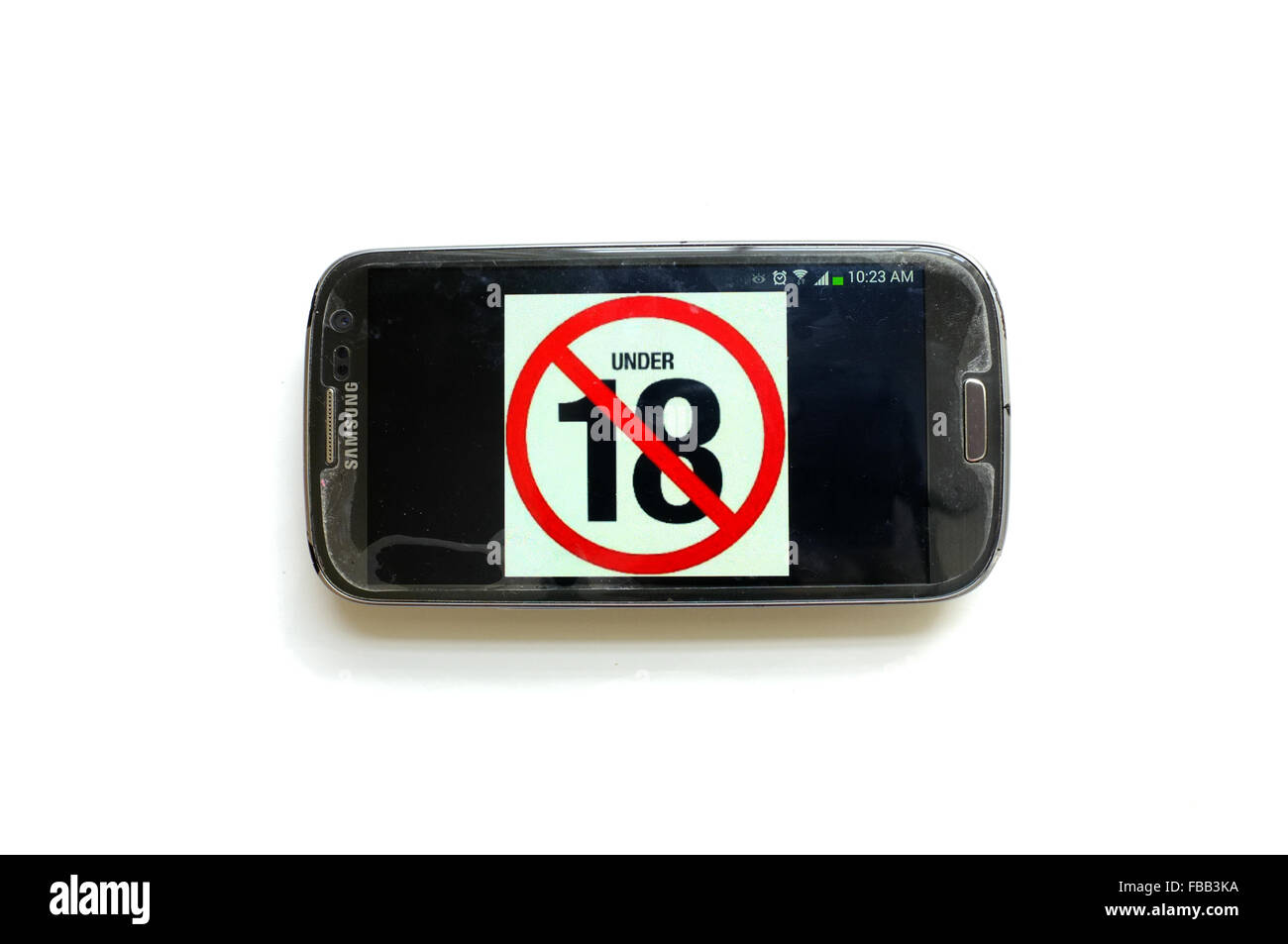 An under 18 image on a smartphone screen photographed against a white background. Stock Photo