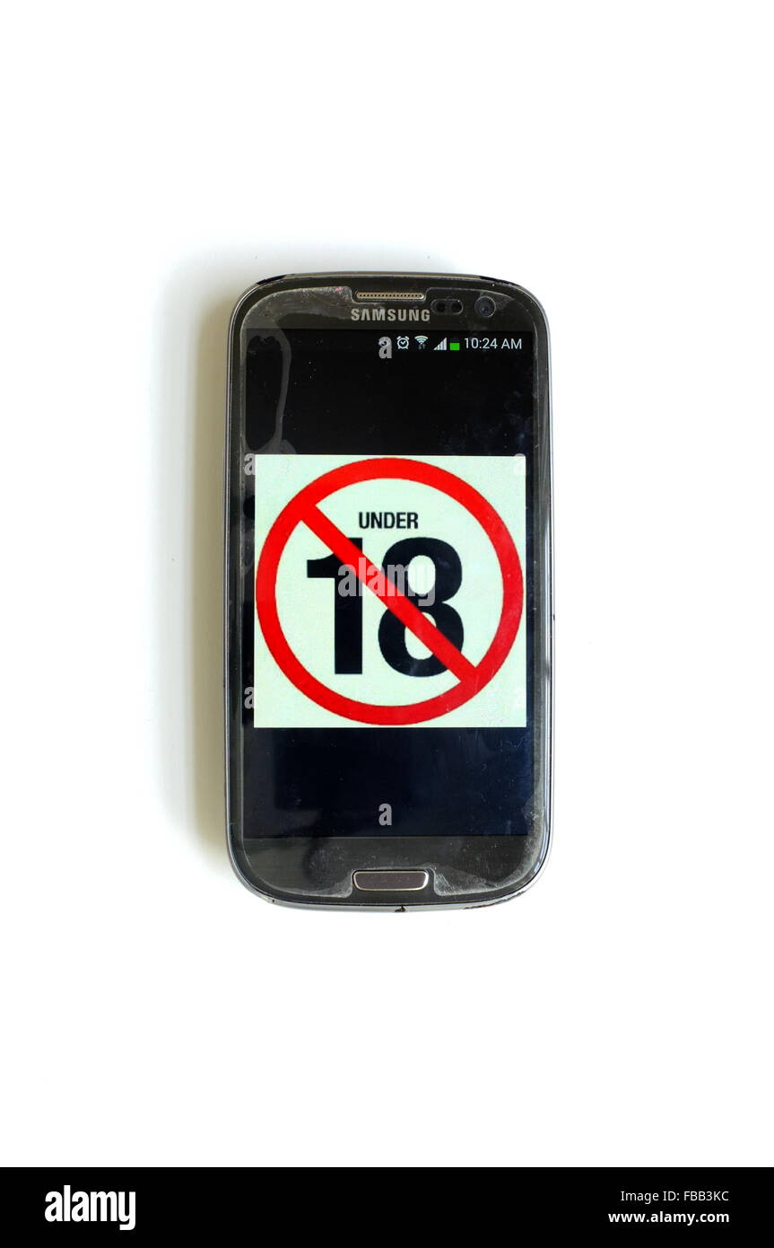 An under 18 image on a smartphone screen photographed against a white background. Stock Photo