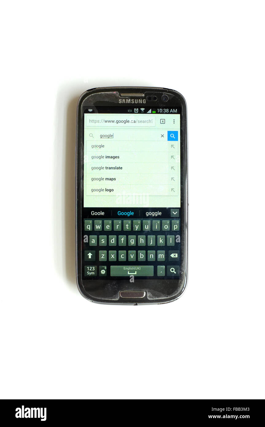 Google search on a smartphone screen photographed against a white background. Stock Photo