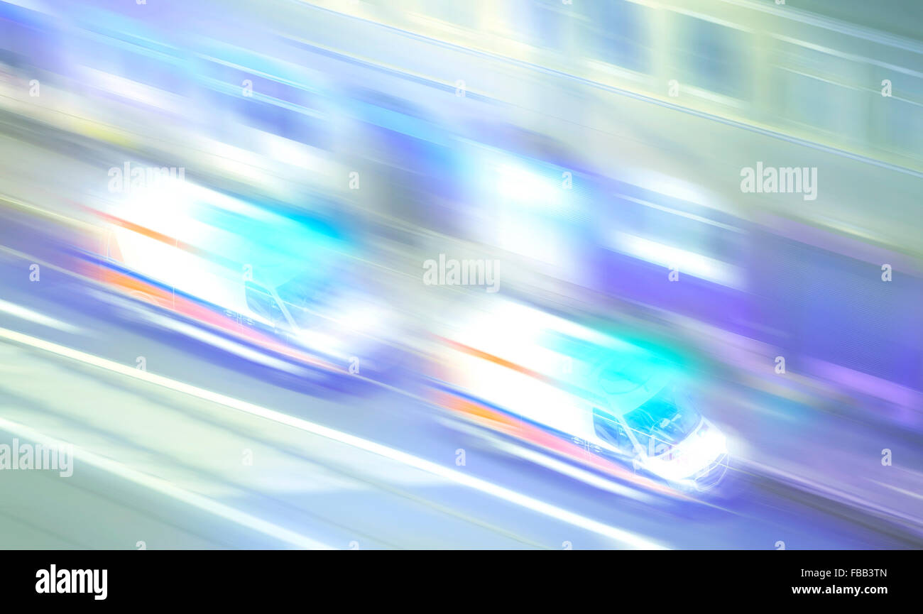 Motion blurred ambulances with flashing lights at night, emergency call concept picture. Stock Photo