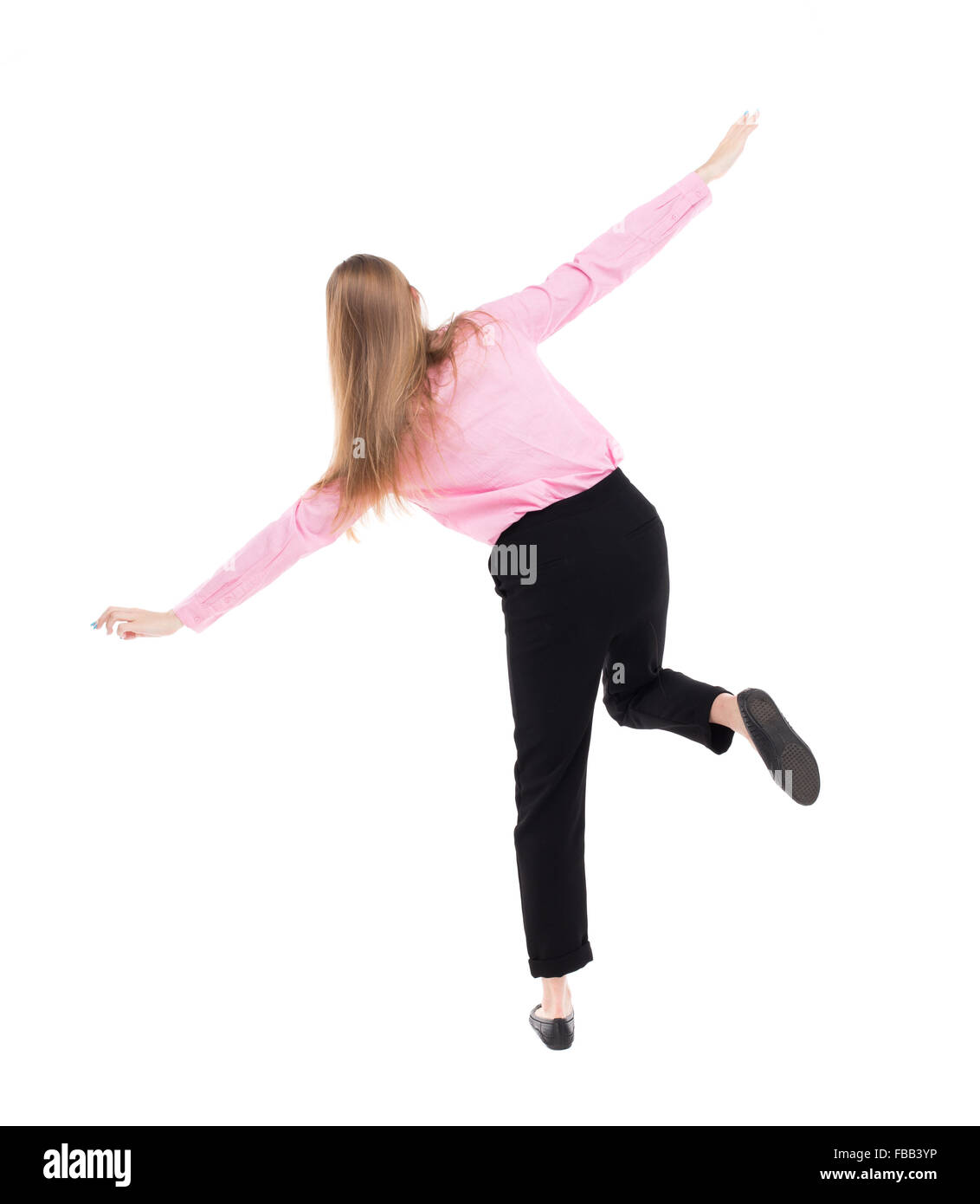 Balancing young business woman. or dodge falling woman. Rear view people collection. backside view of person. Isolated over white background. The girl office worker in black trousers shows the plane. Stock Photo