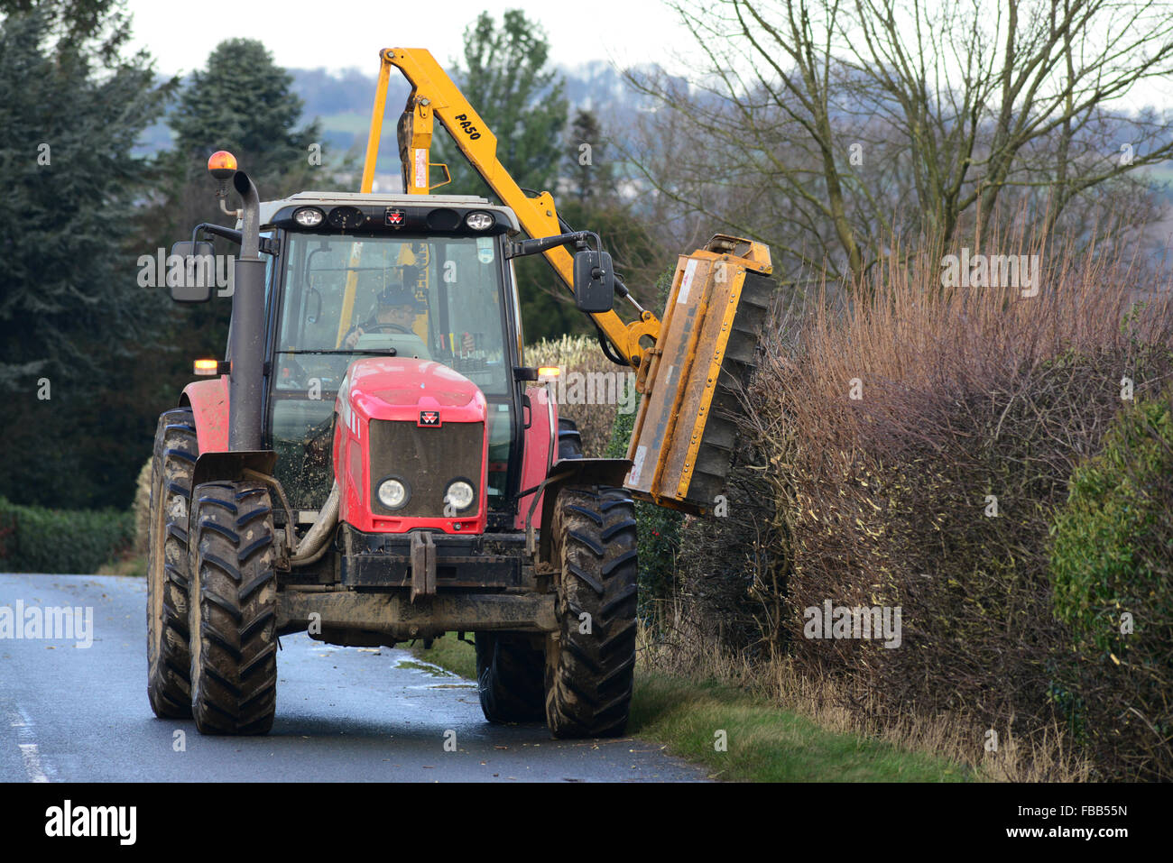 A farmer in his tractor cutting a hedge Stock Photo Alamy