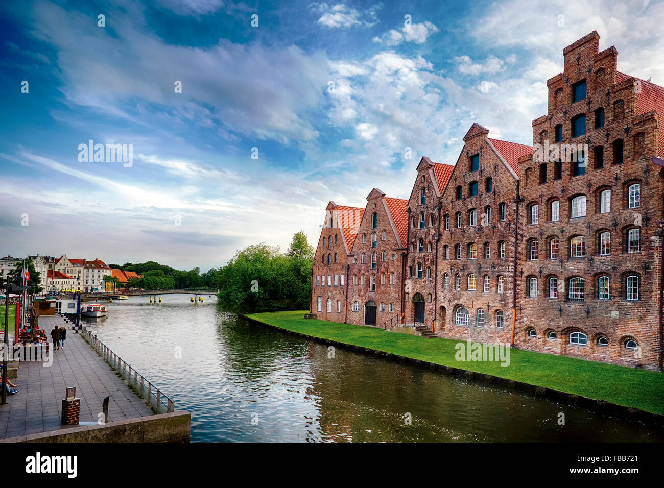 Low Angle View of Old Brick Crow-Stepped Gable Warehouse Buildings Along a Canal, Old Town Lubeck, Schleswig-Holstein, Germany Stock Photo