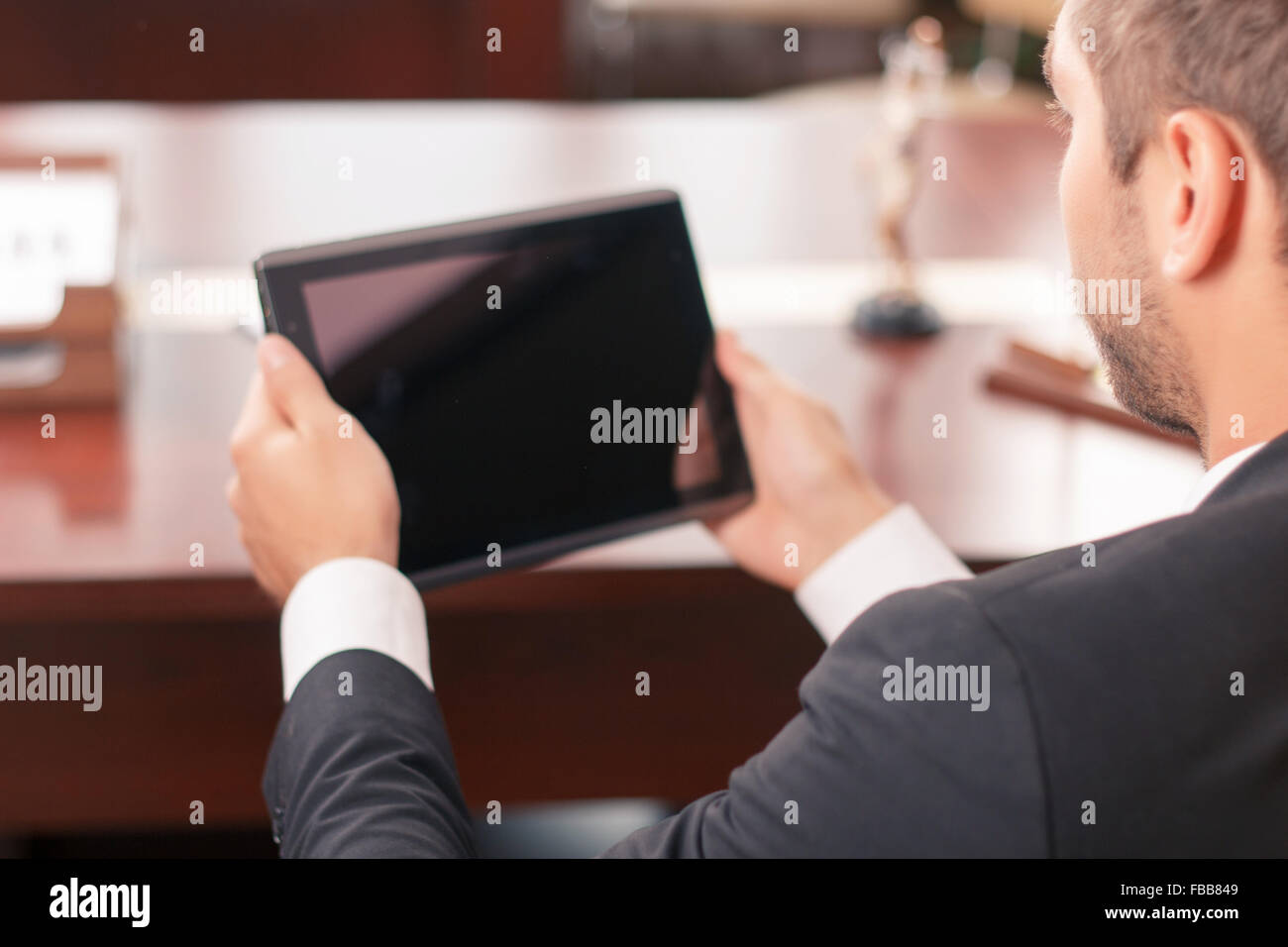 Pleasant lawyer holding laptop Stock Photo Alamy