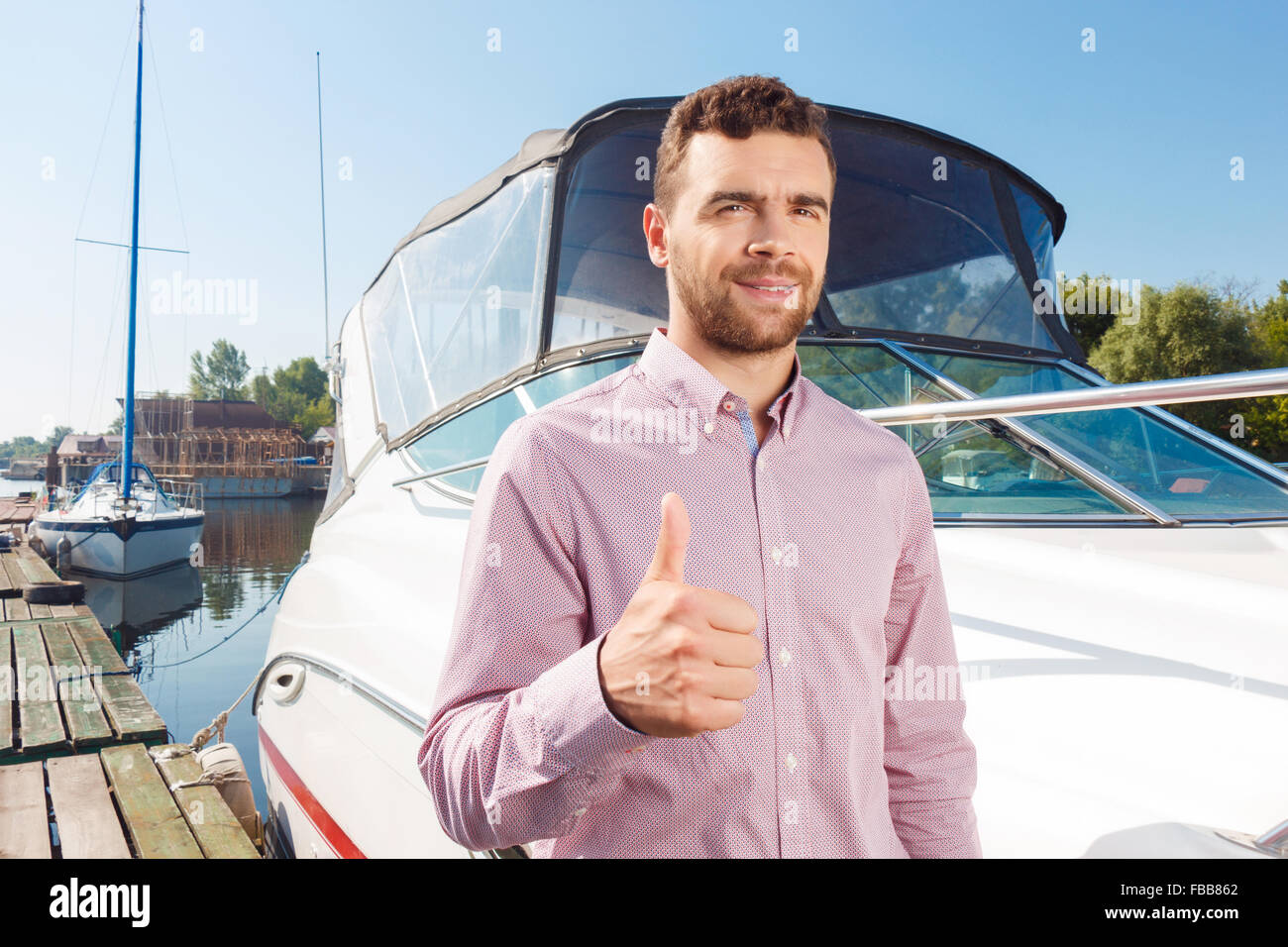Pleasant man thumbing up Stock Photo - Alamy