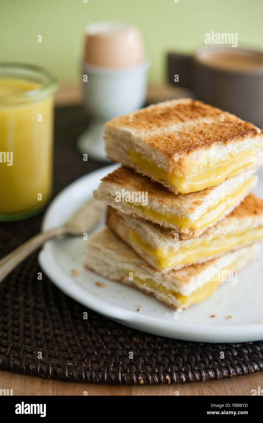 Toast sandwiches with kaya, a southeast asian breakfast spread made of coconut, egg yolks and pandan Stock Photo