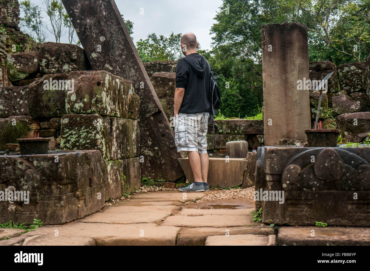 Young man stands in the ruins of a temple at My Son UNESCO World Heritage in Vietnam Stock Photo