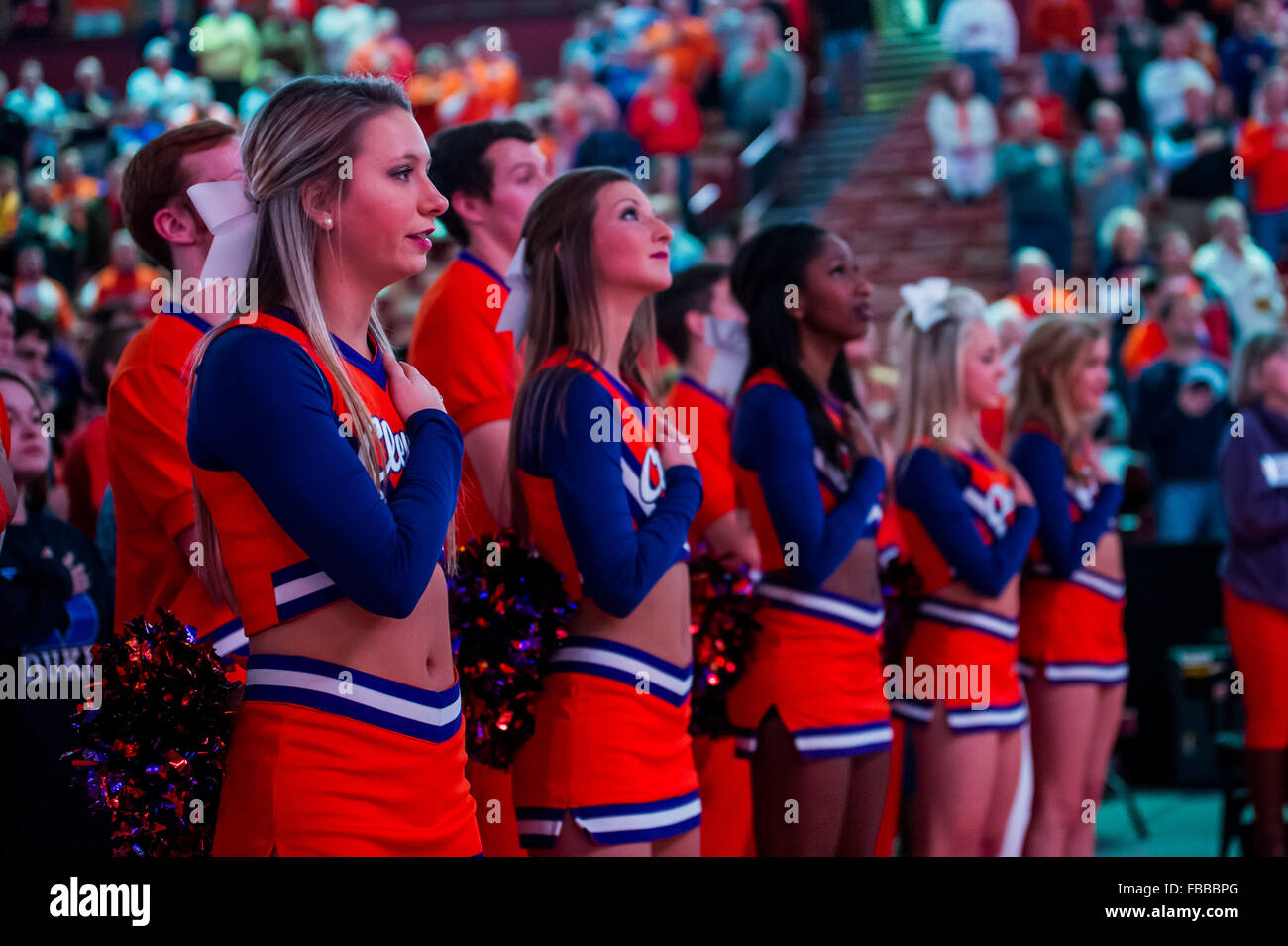 Clemson cheerleaders stand with their hands over their hearts for the