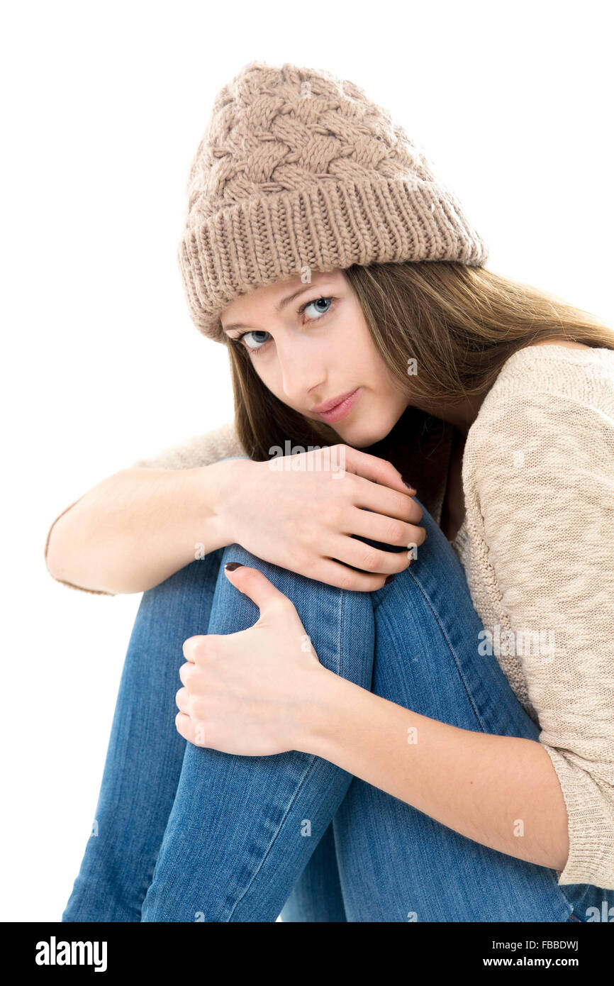 Teens troubles. Frightened teenage girl curled-up, looking afraid, upset, timid Stock Photo