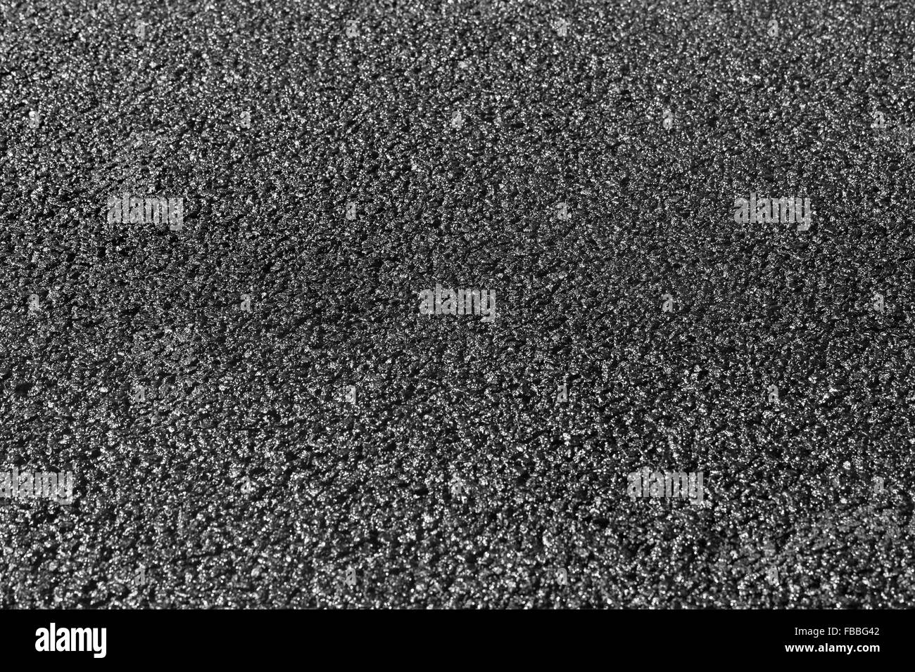 New black asphalt pavement immediately after asphalting, background with selective focus on the middle of the road Stock Photo