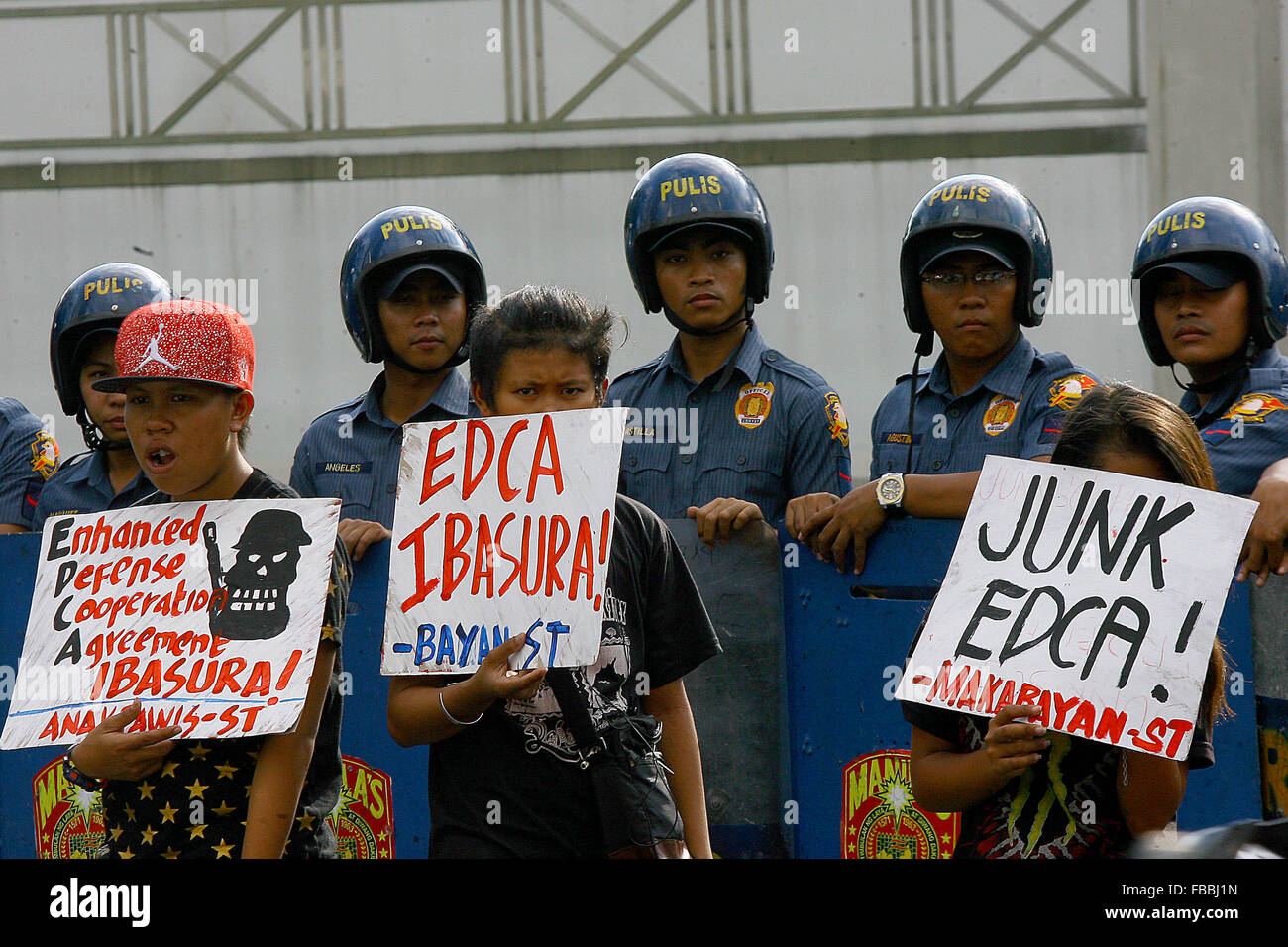 Manila, Philippines. 14th Jan, 2016. Activists hold placards during a protest rally in front of the U.S. Embassy in Manila, the Philippines, Jan. 14, 2016. The activists are calling for an end to the Enhanced Defense Cooperation Agreement (EDCA) after the Philippine Supreme Court decided that the Philippines' defense cooperation deal with the United States is constitutional and does not need the concurrence of the Senate. Credit:  Rouelle Umali/Xinhua/Alamy Live News Stock Photo