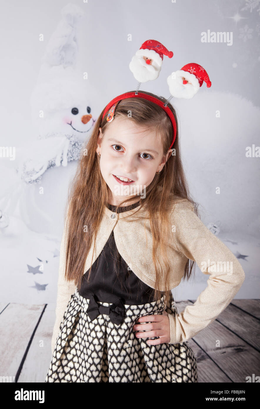 Portrait of a 8 year old girl, nicely dressed, Christmas themed portrait, studio shot. Stock Photo