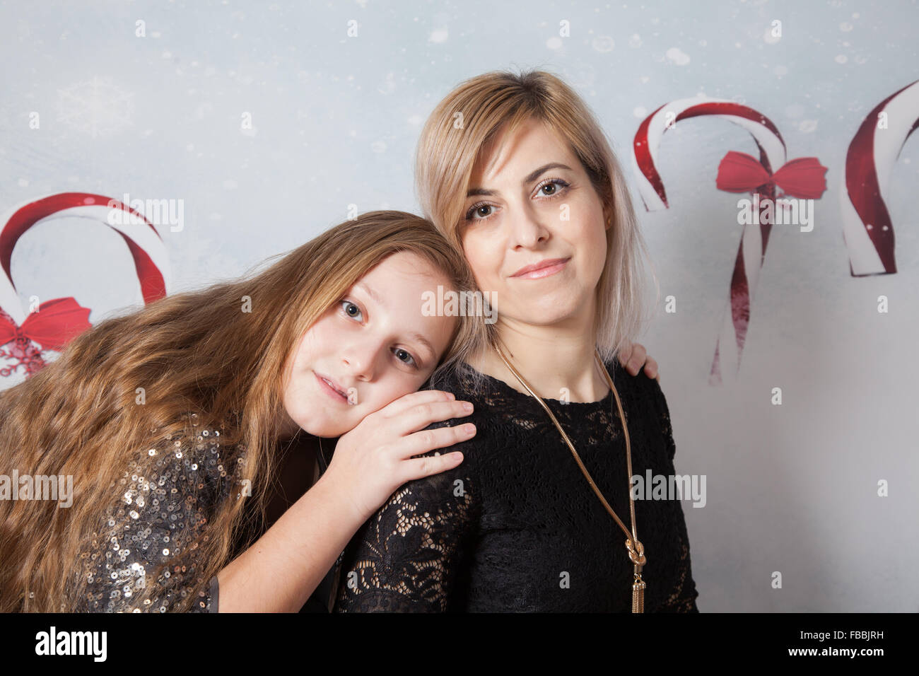 Portrait of a beautiful mother with her daughter, Christmas themed, studio shot. Stock Photo