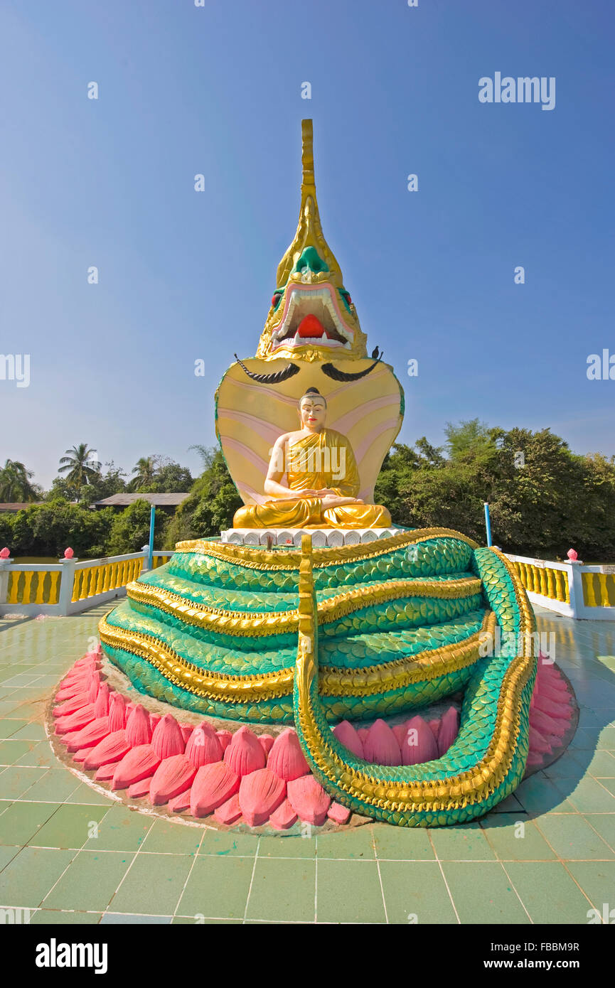 Seated buddah and snake statue in Bago, Myanmar Stock Photo