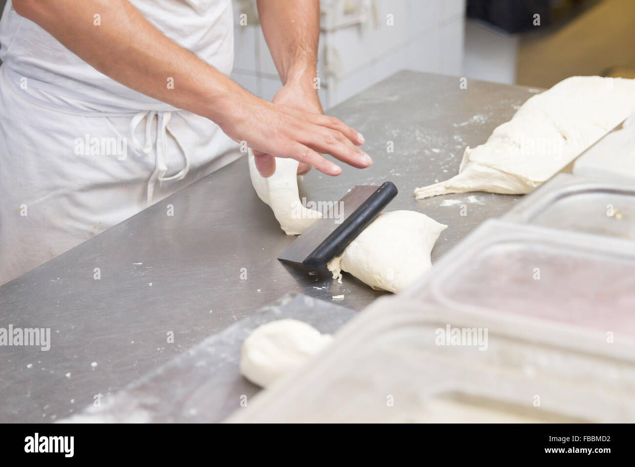 man cook dough knead cut  restaurant kitchen Stock Photo