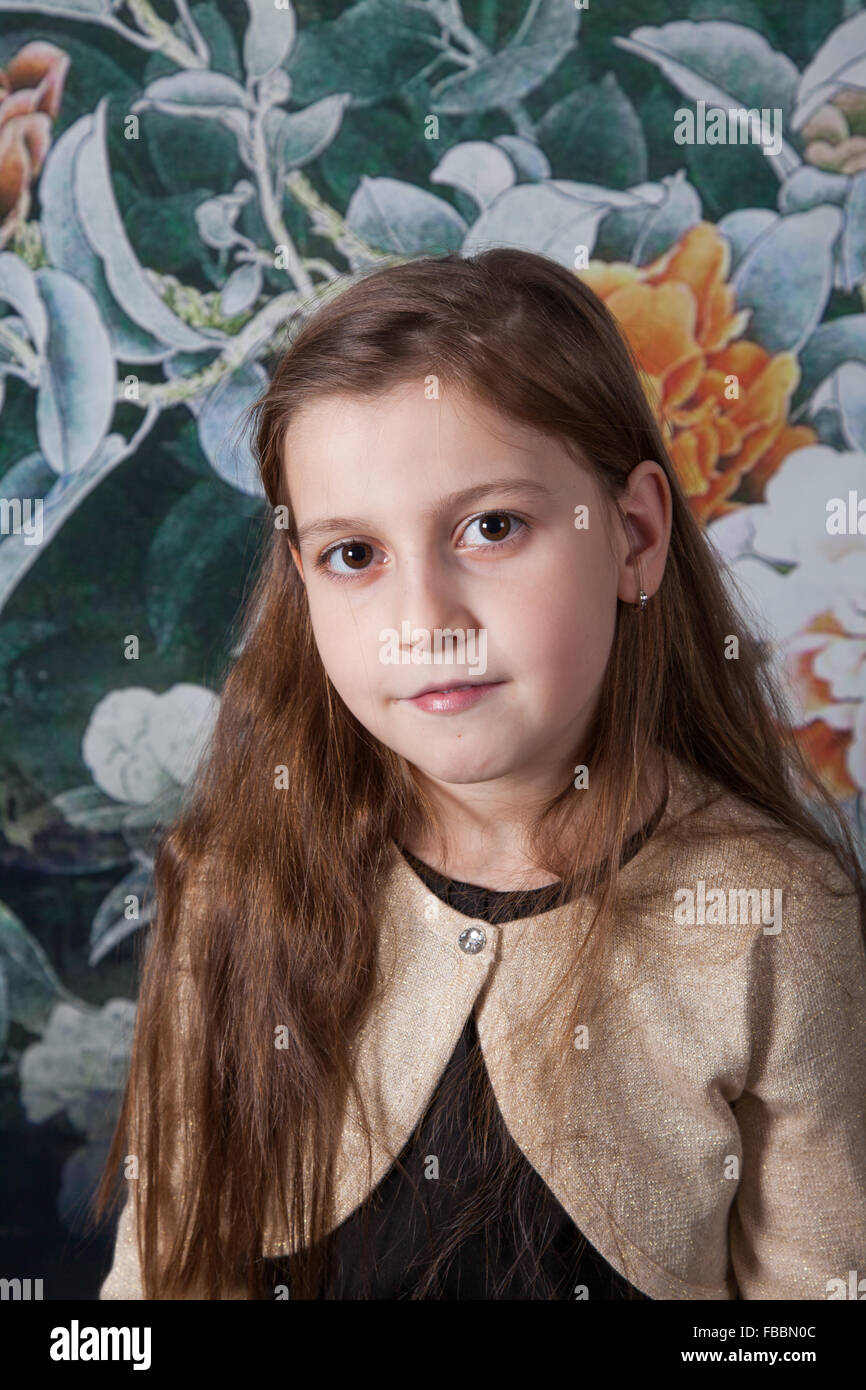 Portrait of a 8 year old girl, nicely dressed over flower background