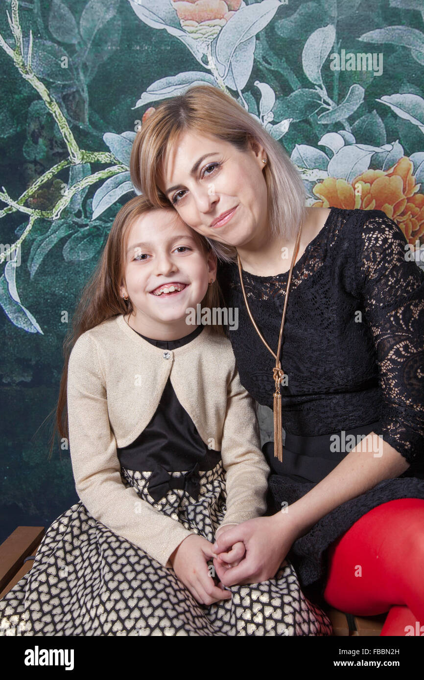 Portrait of a beautiful mother with her daughter, studio shot. Stock Photo