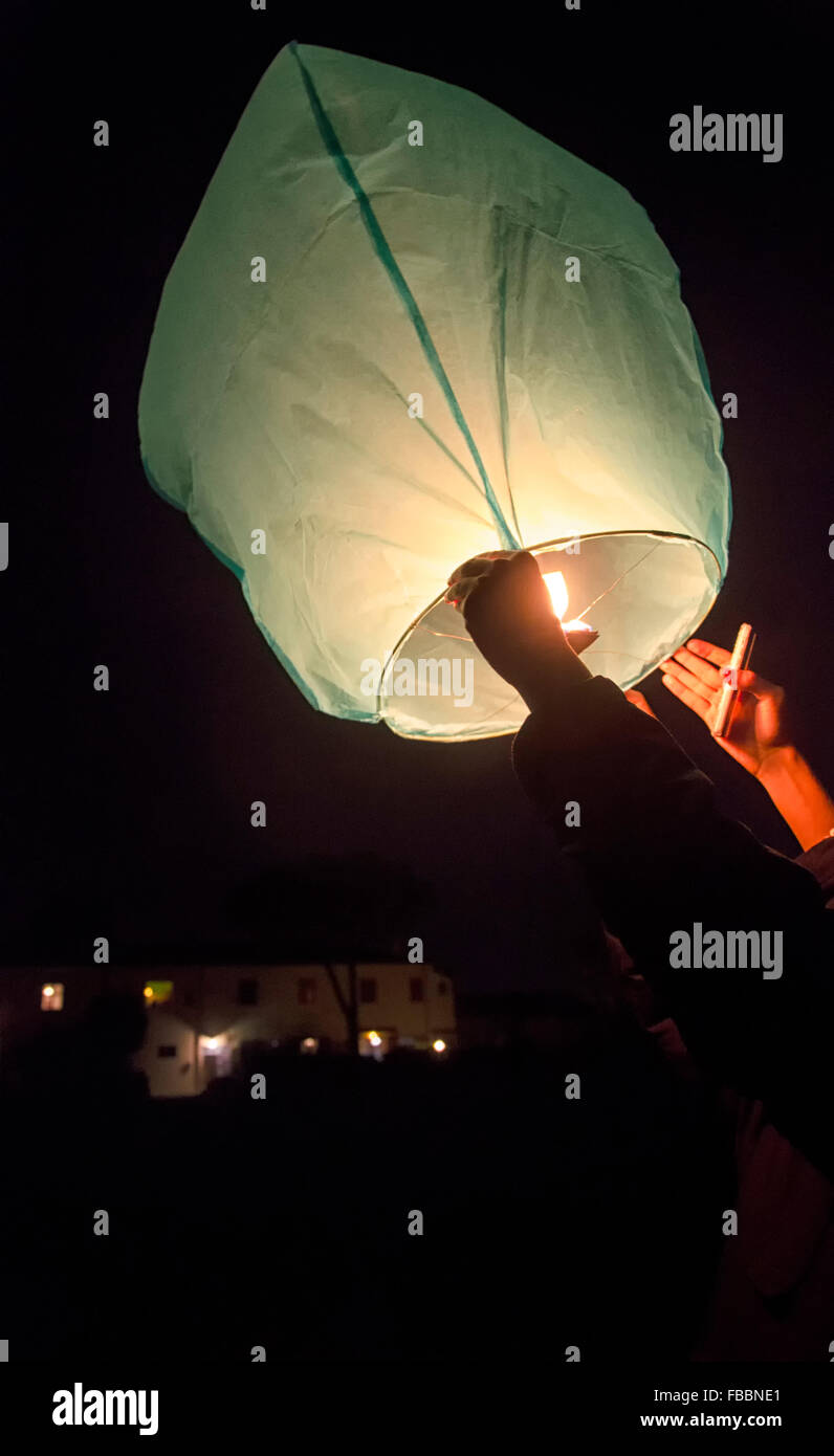 The release of a Chinese lantern to the sky Stock Photo