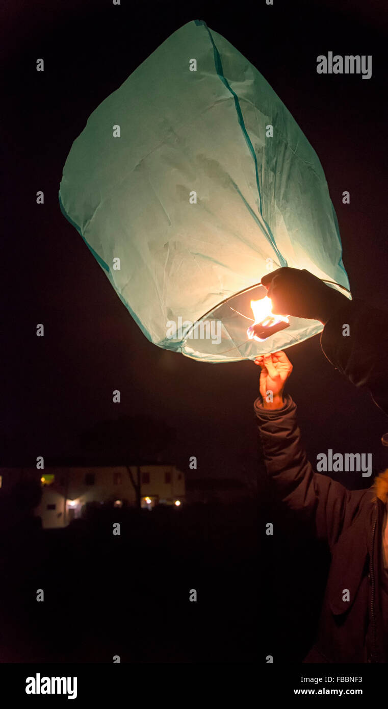 Releasing a Chinese lantern to the sky Stock Photo