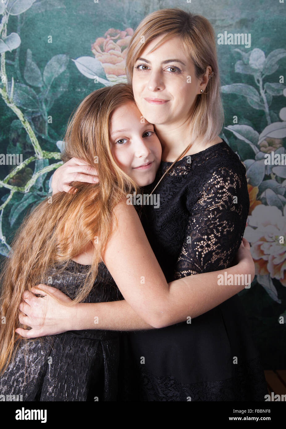 Portrait of a beautiful mother with her daughter, studio shot. Stock Photo