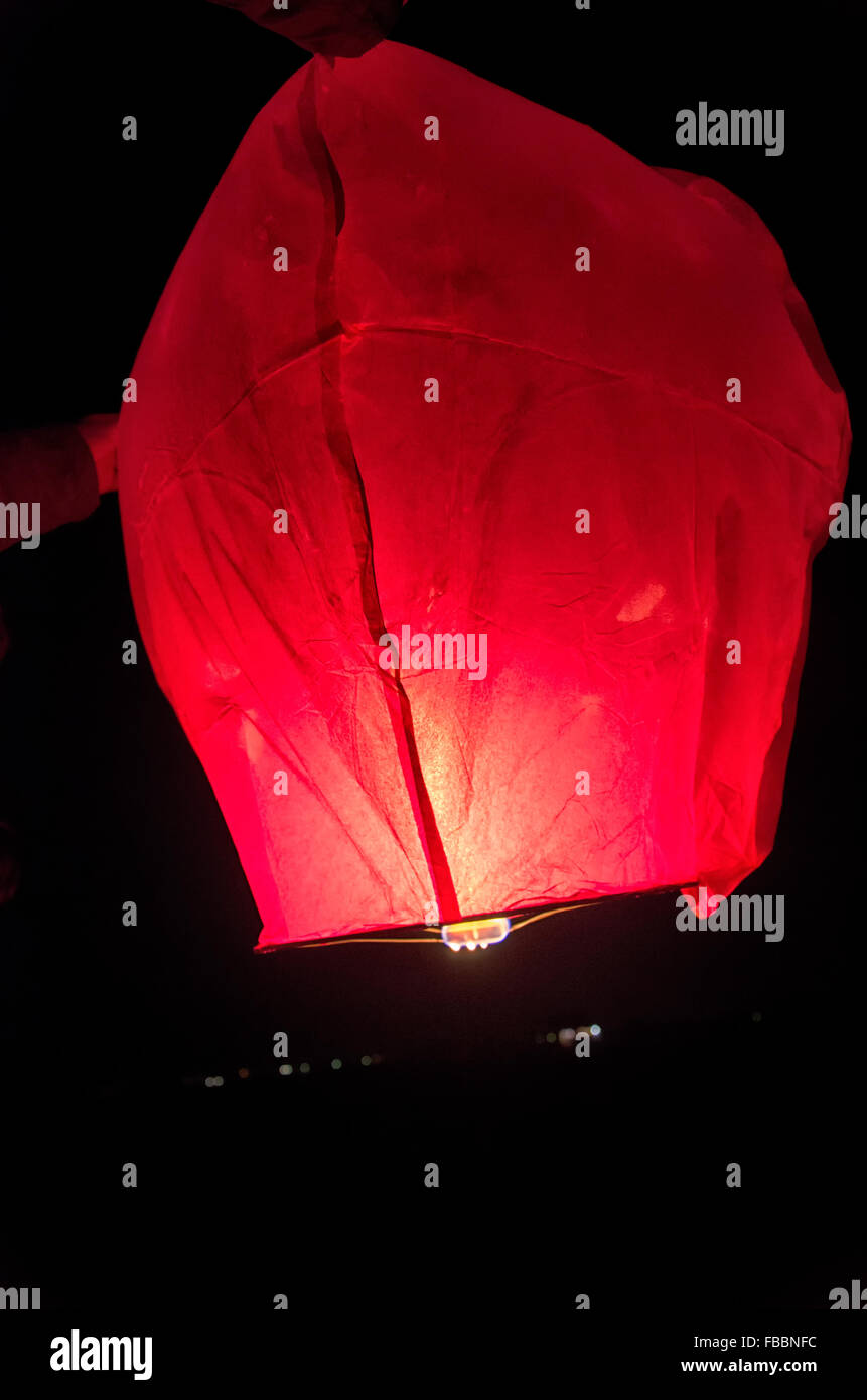 The release of a Chinese lantern into the dark Stock Photo