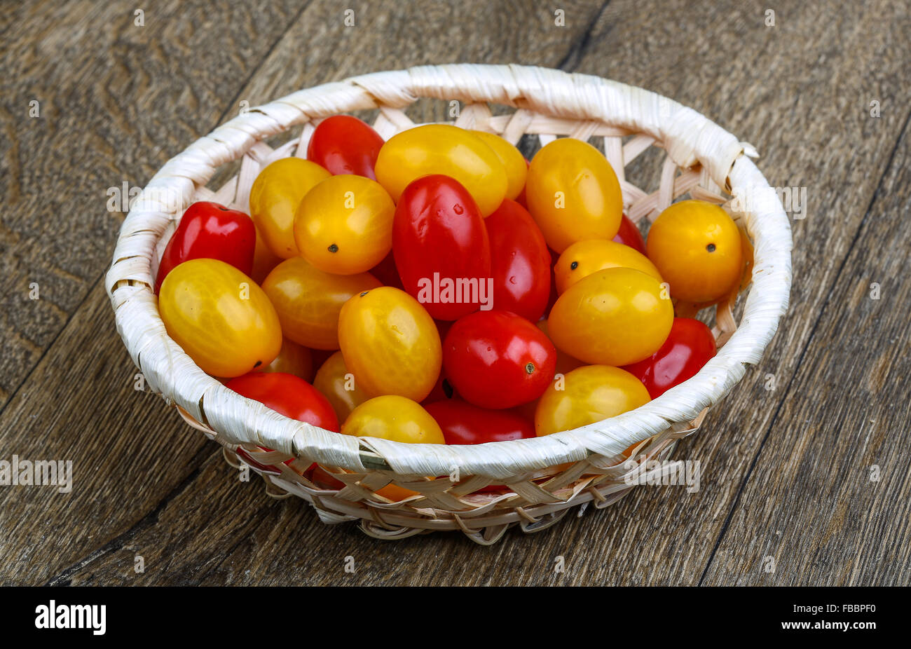 Yellow and red cherry tomatoes mix on the basket Stock Photo - Alamy
