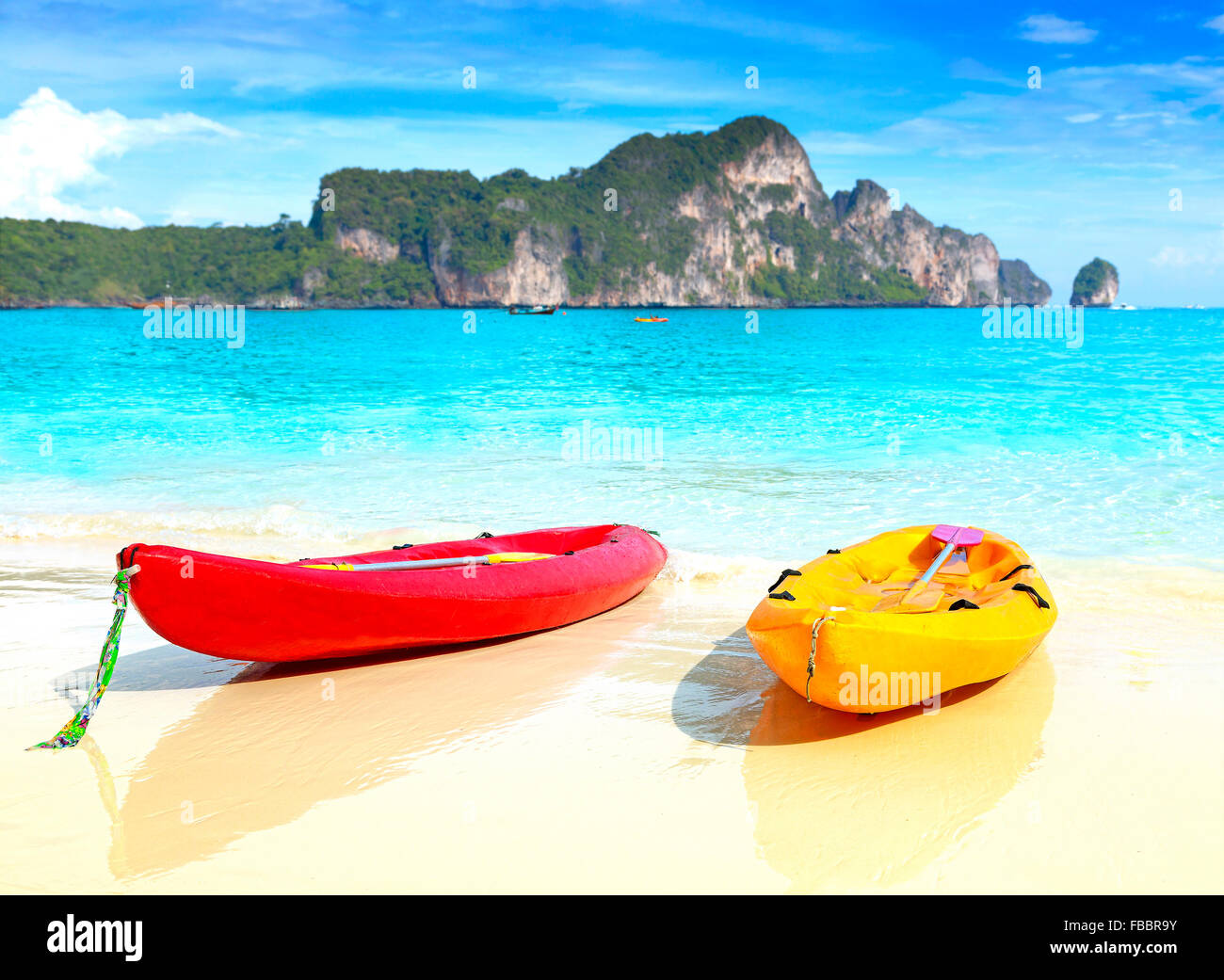 Two kayaks on a tropical beach, shallow depth of field, summer holidays background. Stock Photo