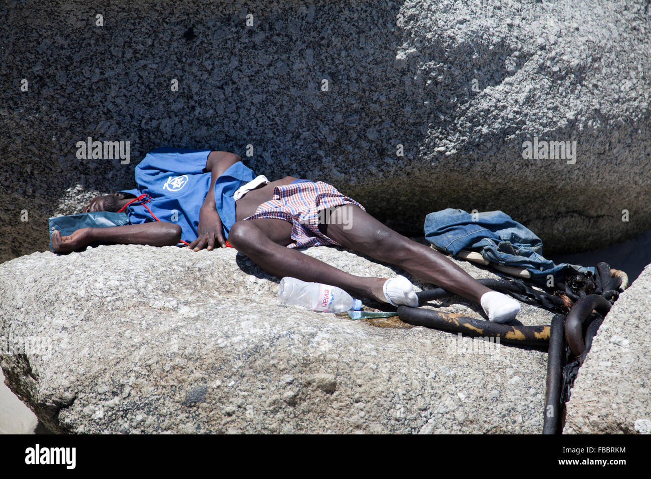 Man Sleeping Rough on Clifton Beach - Cape Town - South Africa Stock Photo